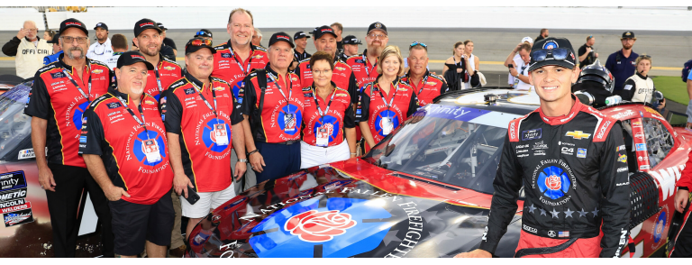 Figure 2: Jesse Love and his crew stand with the Whelen #2 Chevy Camaro displaying the National Fallen Firefighters Foundation (NFFF) commemorative paint scheme 